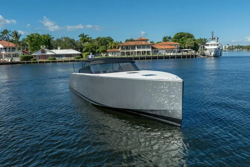L.o.u. Yacht Photos Pics 2016 VanDutch 55 yacht on a sunny waterfront with luxury homes in the background.