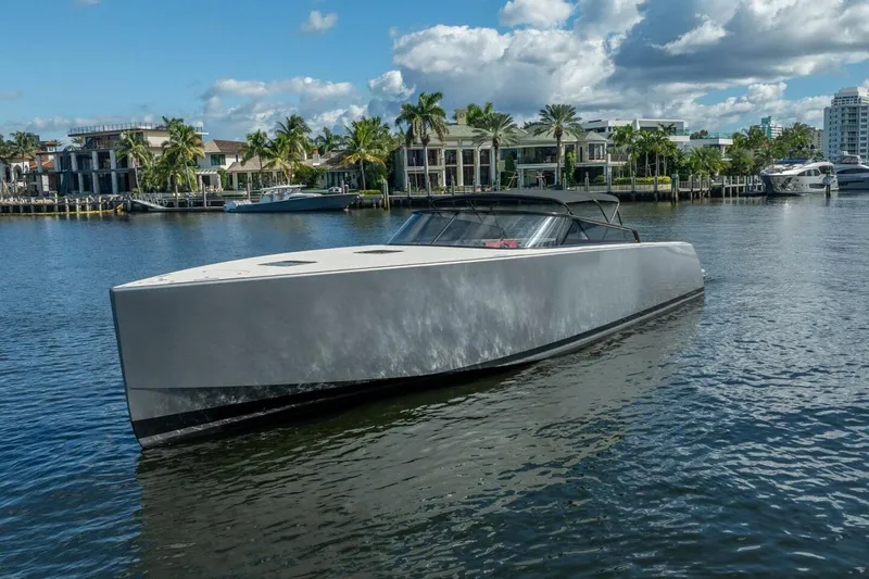 L.o.u. Yacht Photos Pics 2016 VanDutch 55 yacht cruising on a sunny waterfront with palm trees and luxury homes.