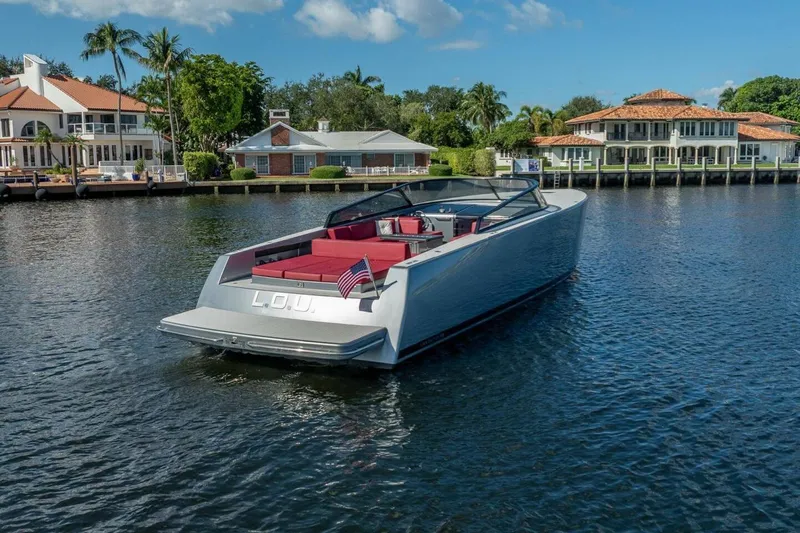 L.o.u. Yacht Photos Pics Luxury 2016 VanDutch 55 yacht on a serene waterfront, surrounded by elegant homes.