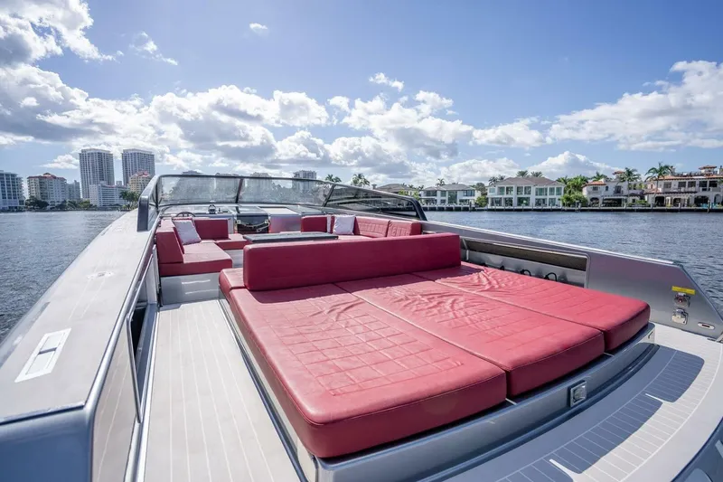 L.o.u. Yacht Photos Pics Luxury 2016 VanDutch 55 yacht with red seating, cruising near waterfront homes.