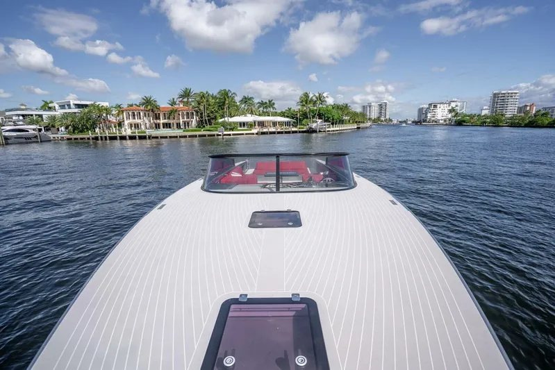L.o.u. Yacht Photos Pics VanDutch 55 yacht cruising on a sunny day, with waterfront homes in the background.