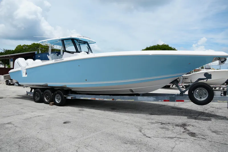  Yacht Photos Pics 2025 Fountain 38 CC boat on trailer, light blue hull, parked outdoors.