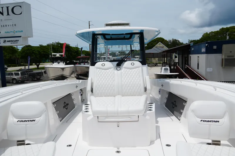  Yacht Photos Pics 2025 Fountain 38 CC boat interior with white seating and modern design.