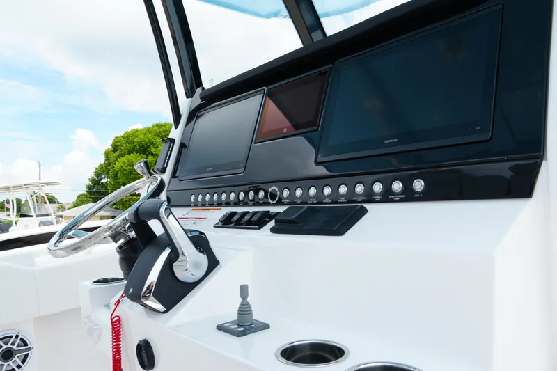 Yacht Photos Pics 2025 Fountain 38 CC boat dashboard with steering wheel and digital displays.
