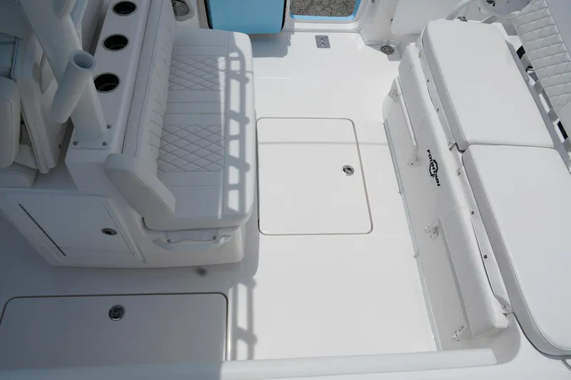  Yacht Photos Pics 2025 Fountain 38 CC boat interior with white seating and storage compartments.