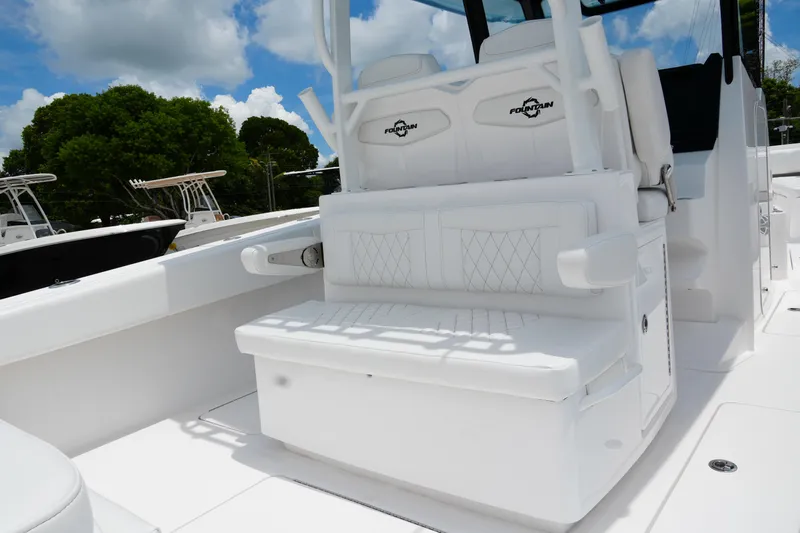  Yacht Photos Pics 2025 Fountain 38 CC boat interior with white seating and sleek design.