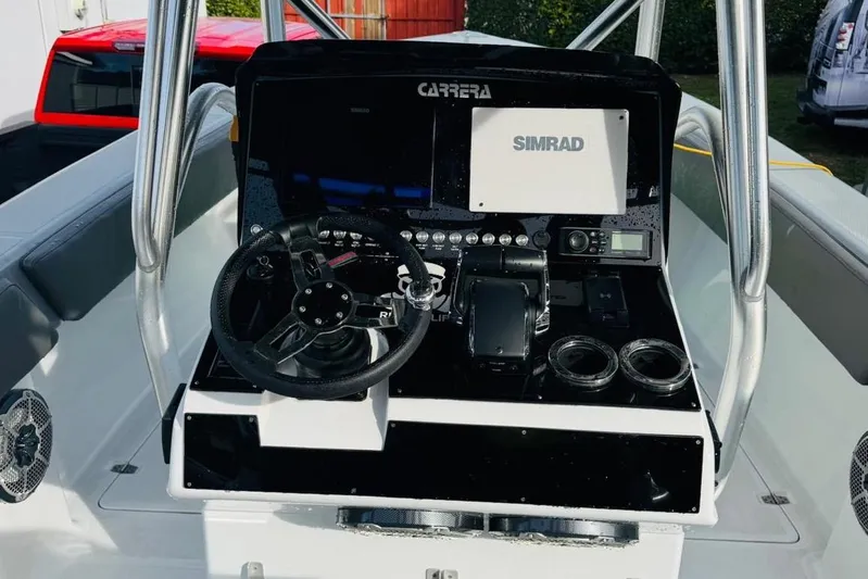  Yacht Photos Pics Cockpit of 2005 Carrera Boats 32 with Simrad navigation system and steering wheel.