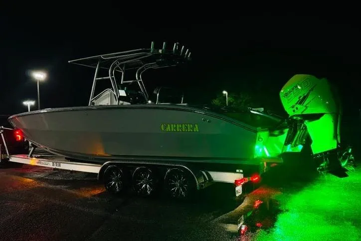  Yacht Photos Pics 2005 Carrera Boats 32 with green lights on trailer at night.