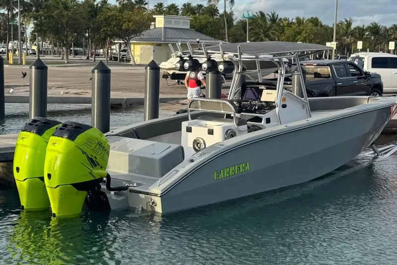  Yacht Photos Pics 2005 Carrera Boats 32 with twin neon green outboard motors docked at marina.
