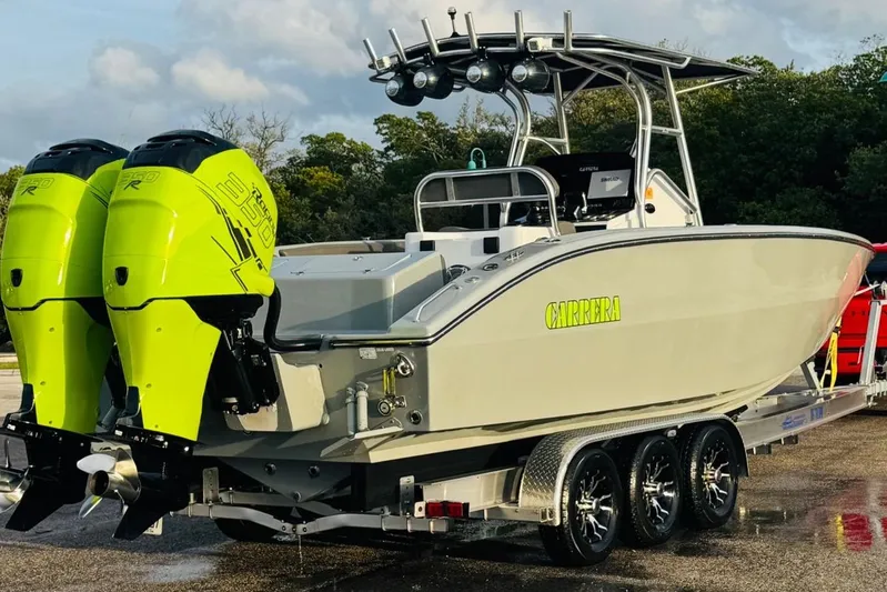  Yacht Photos Pics 2005 Carrera Boats 32 with dual neon green outboard motors on a trailer.