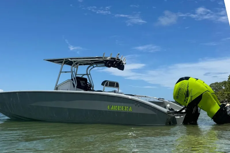  Yacht Photos Pics 2005 Carrera Boats 32 in water, featuring vibrant yellow engine, under clear blue sky.