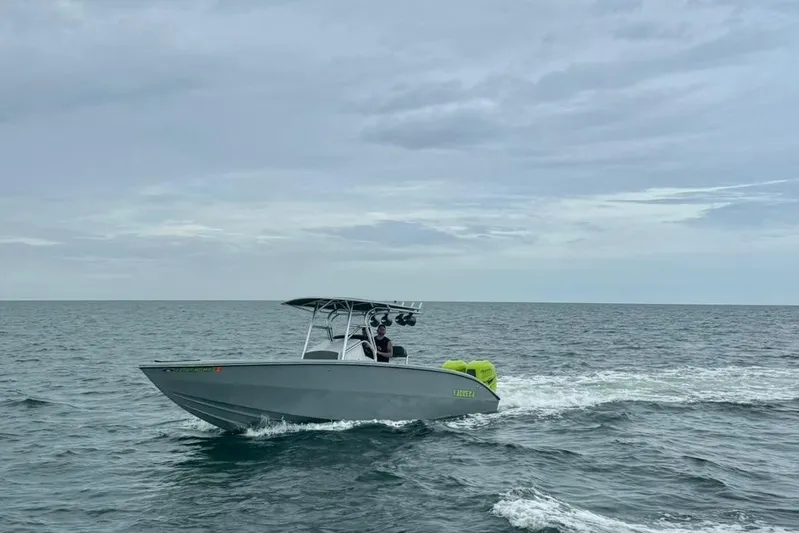  Yacht Photos Pics 2005 Carrera Boats 32 cruising on open water under cloudy skies.