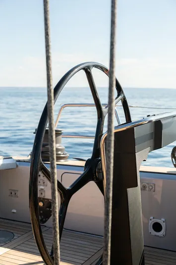 Caiarossa Yacht Photos Pics Steering wheel of 2009 Shipman 72 yacht on open sea.