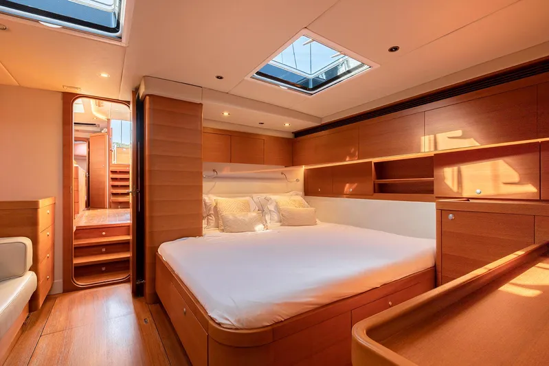 Caiarossa Yacht Photos Pics Luxurious Shipman 72 yacht bedroom interior, featuring elegant wood finishes and soft lighting, 2009 model.