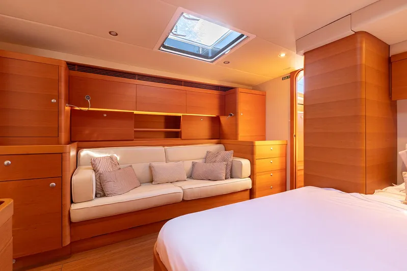 Caiarossa Yacht Photos Pics Luxurious interior of 2009 Shipman 72 yacht with wooden cabinetry and comfortable seating.