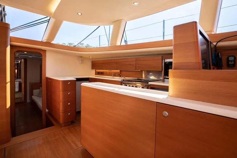 Caiarossa Yacht Photos Pics Luxurious interior of 2009 Shipman 72 yacht with modern wooden cabinetry and skylights.