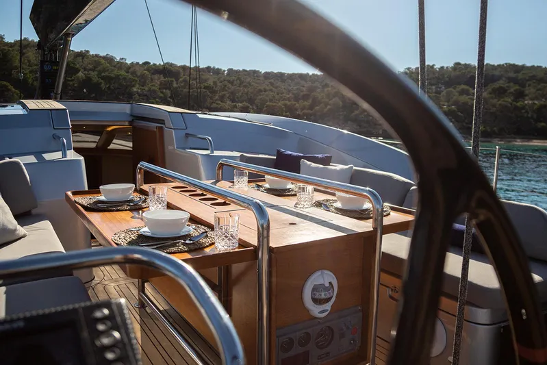 Caiarossa Yacht Photos Pics Luxurious 2009 Shipman 72 yacht interior with elegant dining setup and scenic ocean view.