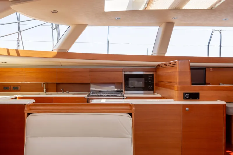 Caiarossa Yacht Photos Pics Luxurious Shipman 72 yacht interior kitchen with modern appliances and sleek wooden cabinetry, 2009 model.