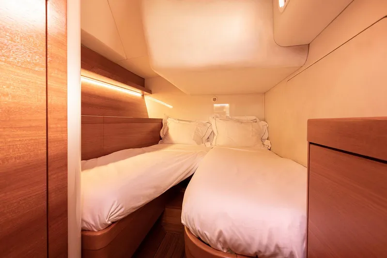 Caiarossa Yacht Photos Pics Luxurious twin cabin interior on 2009 Shipman 72 yacht, featuring elegant wood finishes.