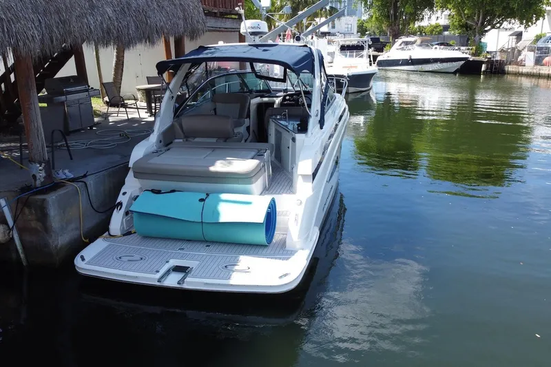 Panacea Yacht Photos Pics 2015 Regal 32 Express boat docked in a serene marina setting.