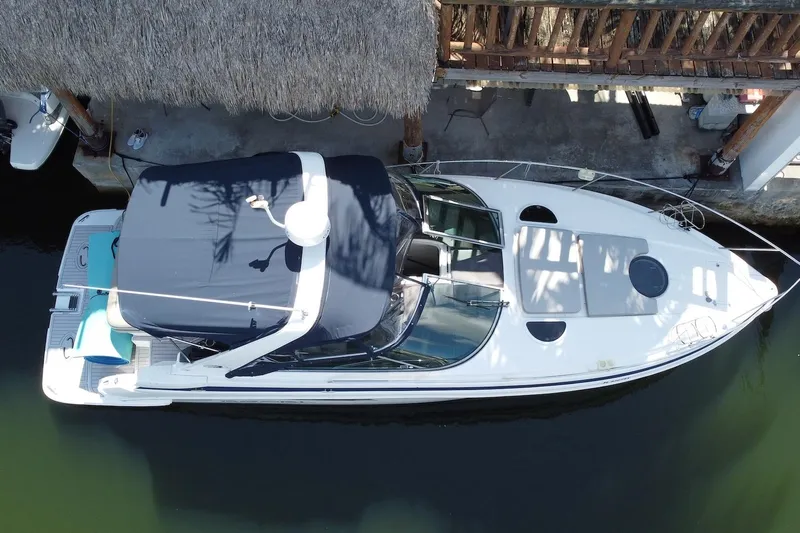Panacea Yacht Photos Pics 2015 Regal 32 Express boat docked under a thatched roof, aerial view.