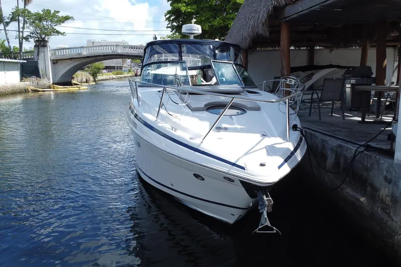 Panacea Yacht Photos Pics 2015 Regal 32 Express boat docked by a canal under a bridge.