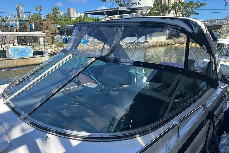 Panacea Yacht Photos Pics 2015 Regal 32 Express boat docked, featuring a sleek windshield and canopy.