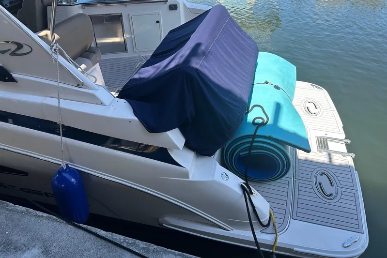 Panacea Yacht Photos Pics 2015 Regal 32 Express boat with covered seating and rolled mats on the deck.