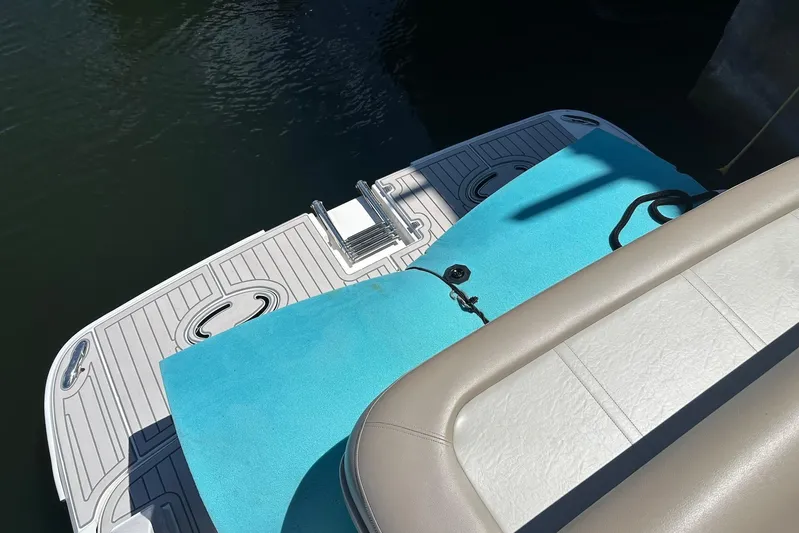 Panacea Yacht Photos Pics 2015 Regal 32 Express boat deck with blue mat and seating.