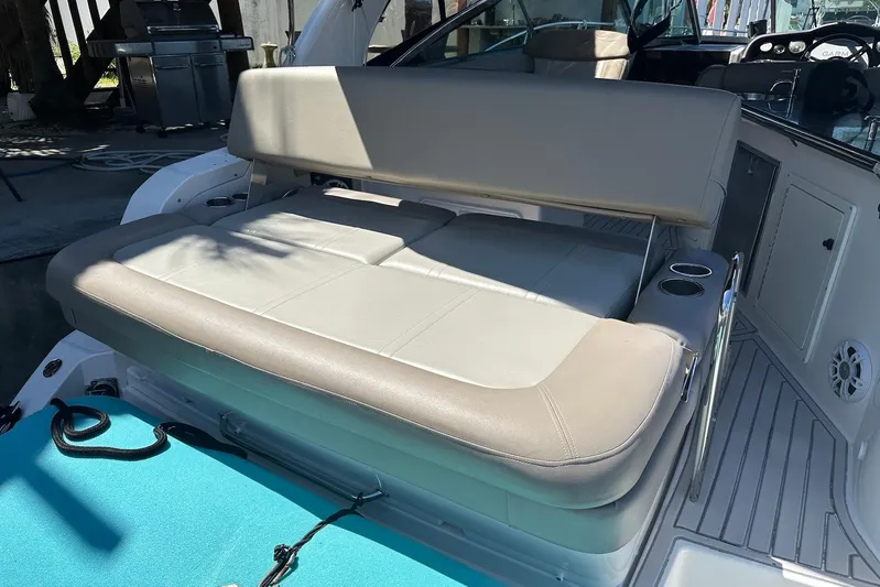 Panacea Yacht Photos Pics 2015 Regal 32 Express boat interior with beige seating and cup holders.