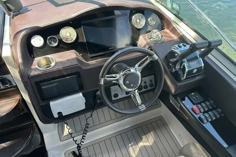 Panacea Yacht Photos Pics Cockpit of 2015 Regal 32 Express boat with steering wheel and control panel.