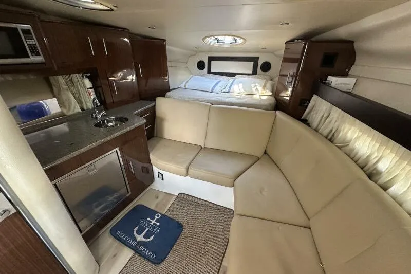 Panacea Yacht Photos Pics Interior of 2015 Regal 32 Express yacht with kitchenette and seating area.
