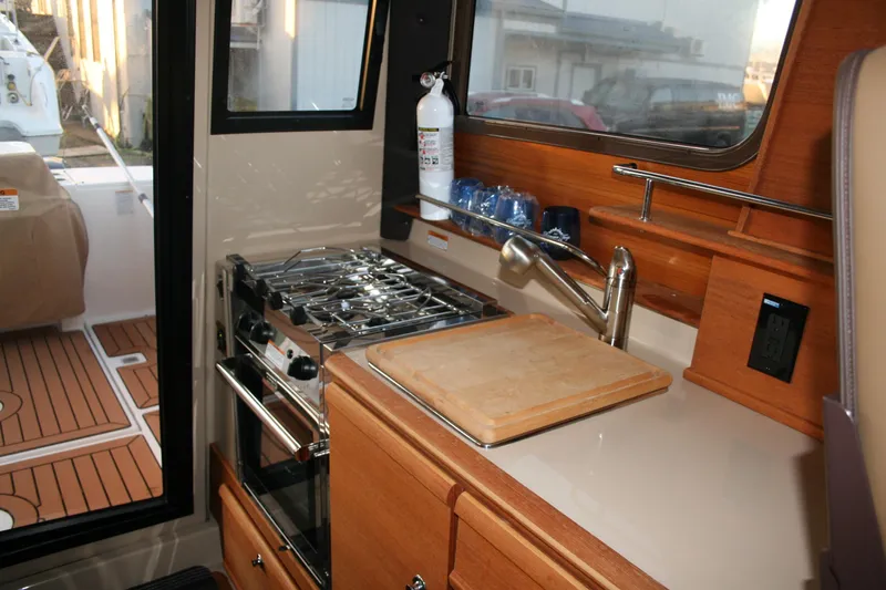 Little Toot Yacht Photos Pics 2019 Ranger Tugs R-27 boat kitchen with stove, sink, and cutting board.