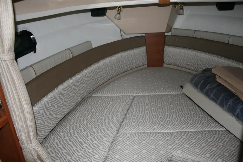 Little Toot Yacht Photos Pics 2019 Ranger Tugs R-27 cabin interior with patterned cushions and cozy bedding.