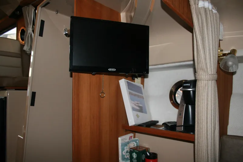 Little Toot Yacht Photos Pics Interior of 2019 Ranger Tugs R-27 with TV, coffee maker, and porthole window.