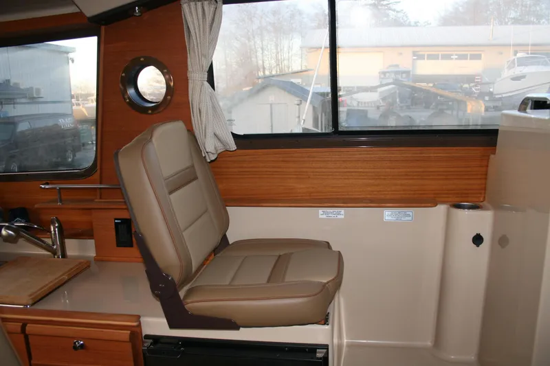 Little Toot Yacht Photos Pics 2019 Ranger Tugs R-27 interior with tan seating and wood accents.