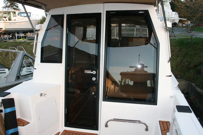 Little Toot Yacht Photos Pics 2019 Ranger Tugs R-27 boat exterior with glass door and window, docked outdoors.