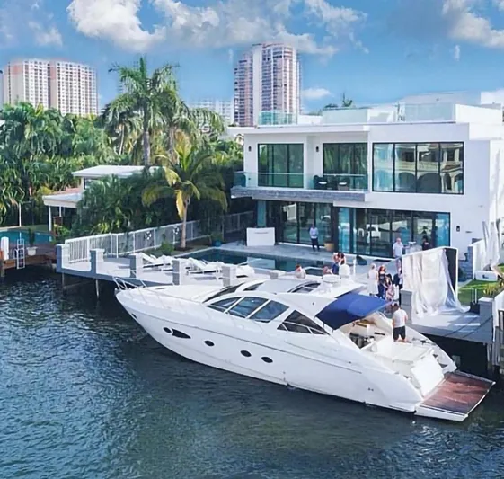 Sol Yacht Photos Pics Luxury Azimut Atlantis 54 yacht docked at modern waterfront mansion, 2010 model.