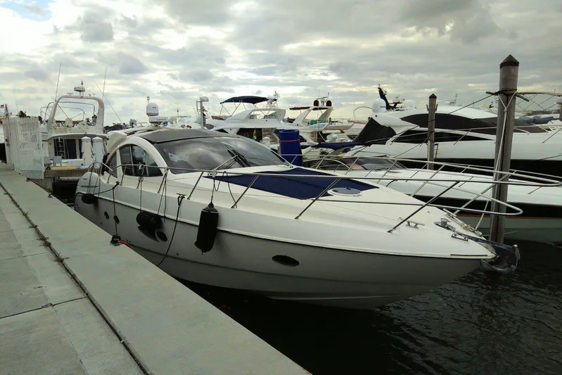 Sol Yacht Photos Pics 2010 Azimut Atlantis 54 yacht docked at marina under cloudy sky.