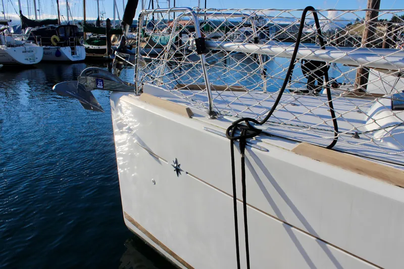 Selkie Yacht Photos Pics Jeanneau Sun Odyssey 349 sailboat docked in marina, 2015 model, with anchor and safety netting.