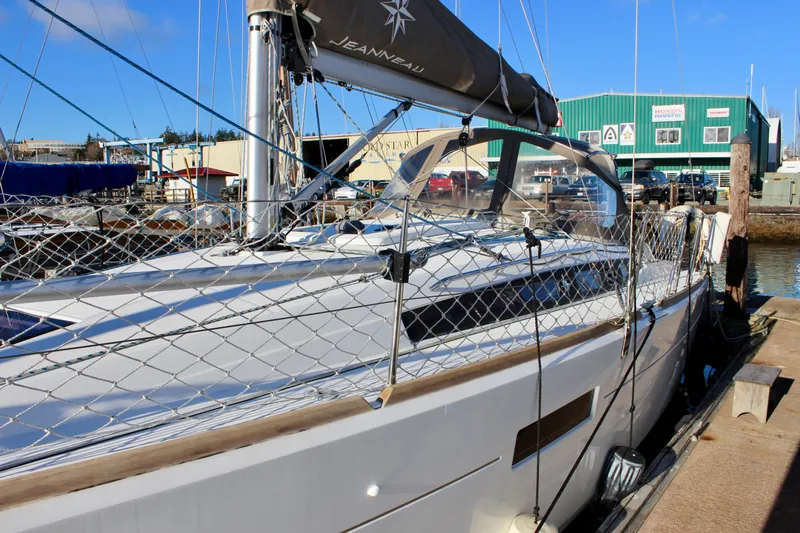 Selkie Yacht Photos Pics 2015 Jeanneau Sun Odyssey 349 sailboat docked at marina, sunny day.