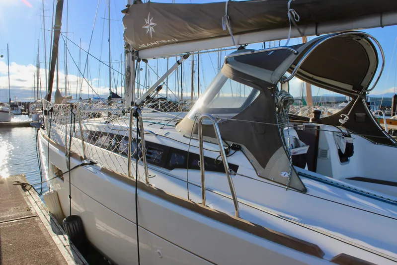 Selkie Yacht Photos Pics 2015 Jeanneau Sun Odyssey 349 sailboat docked in a sunny marina.