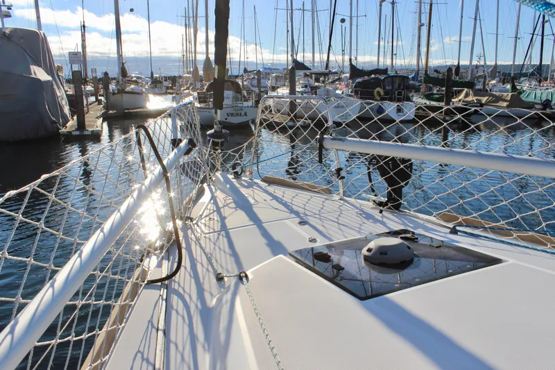 Selkie Yacht Photos Pics 2015 Jeanneau Sun Odyssey 349 sailboat docked in a marina, surrounded by other boats.