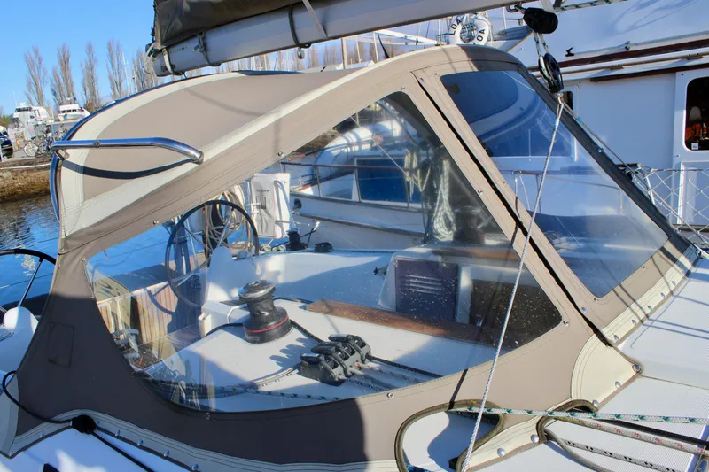 Selkie Yacht Photos Pics 2015 Jeanneau Sun Odyssey 349 sailboat cockpit with protective canopy and steering wheel.