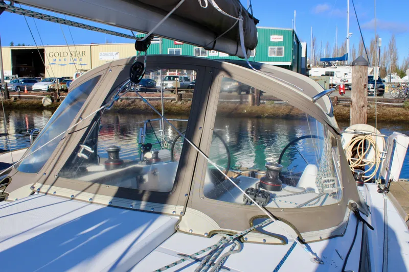 Selkie Yacht Photos Pics 2015 Jeanneau Sun Odyssey 349 sailboat docked at marina, clear canopy, sunny day.