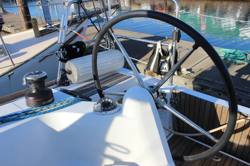 Selkie Yacht Photos Pics 2015 Jeanneau Sun Odyssey 349 cockpit with steering wheel and nautical equipment.