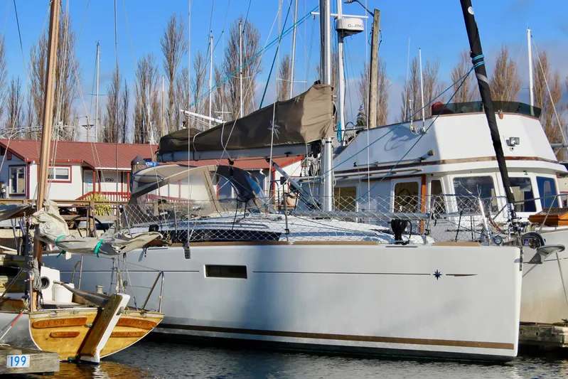 Selkie Yacht Photos Pics 2015 Jeanneau Sun Odyssey 349 sailboat docked at marina with clear blue sky.