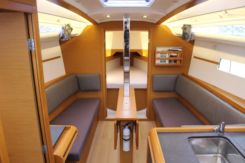 Selkie Yacht Photos Pics Interior of 2015 Jeanneau Sun Odyssey 349 sailboat, featuring cozy seating and modern amenities.