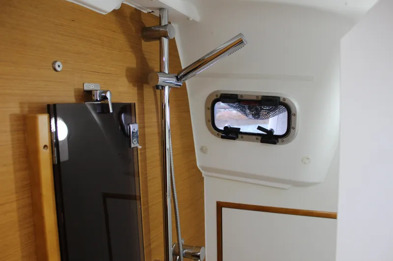 Selkie Yacht Photos Pics Interior of 2015 Jeanneau Sun Odyssey 349 yacht, featuring a shower and porthole window.