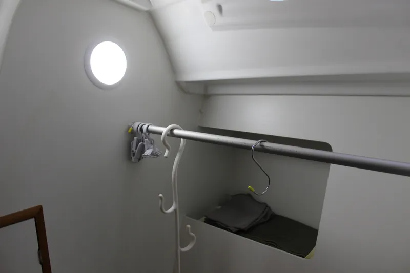 Selkie Yacht Photos Pics Interior of 2015 Jeanneau Sun Odyssey 349 sailboat, featuring a storage area with hangers.
